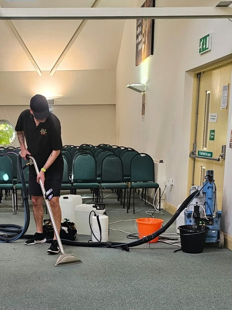 Paul of D&P Carpet Cleaning deep-cleaning a hall carpet with a hot-water extraction machine